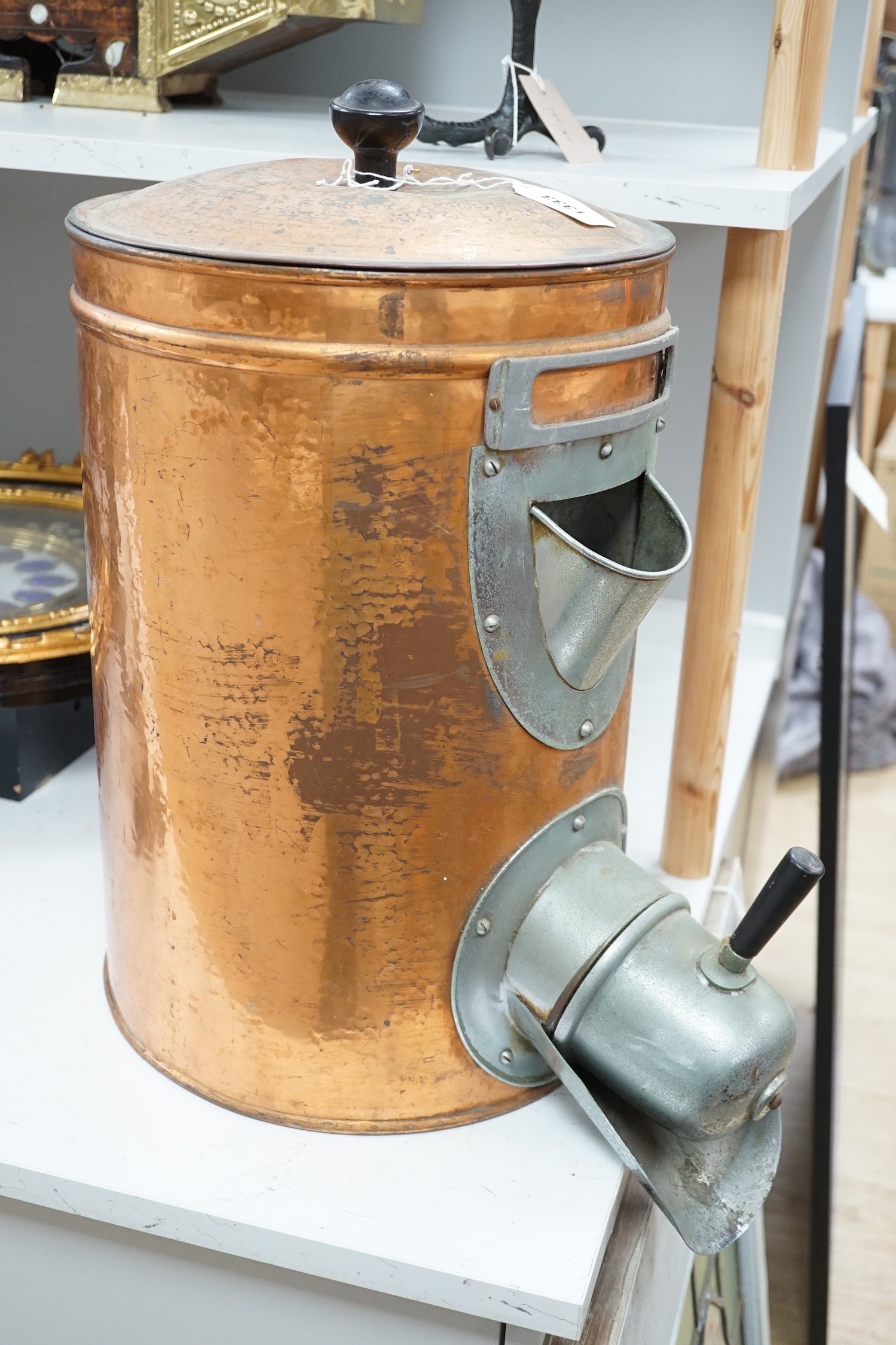 A copper coffee bean dispenser. 60cm high